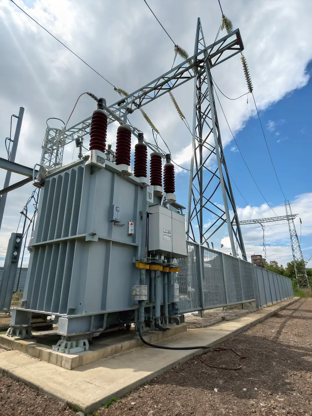 A close-up shot of a high-voltage transformer in a power substation, showcasing the critical role of transformer oil in cooling and insulation, ensuring reliable power distribution.